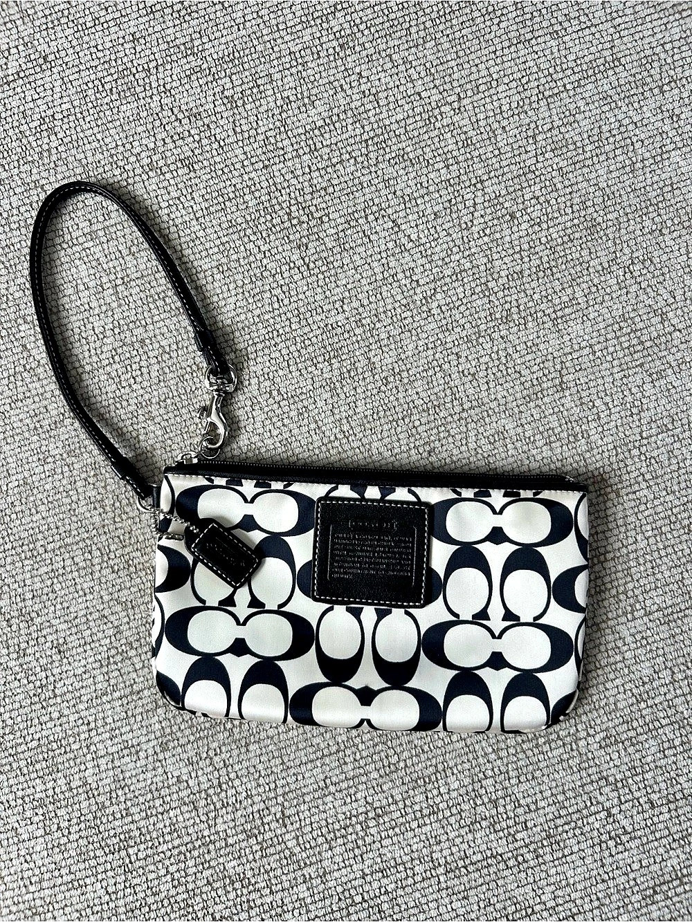 Coach Signature C print nylon wristlet with a black leather strap